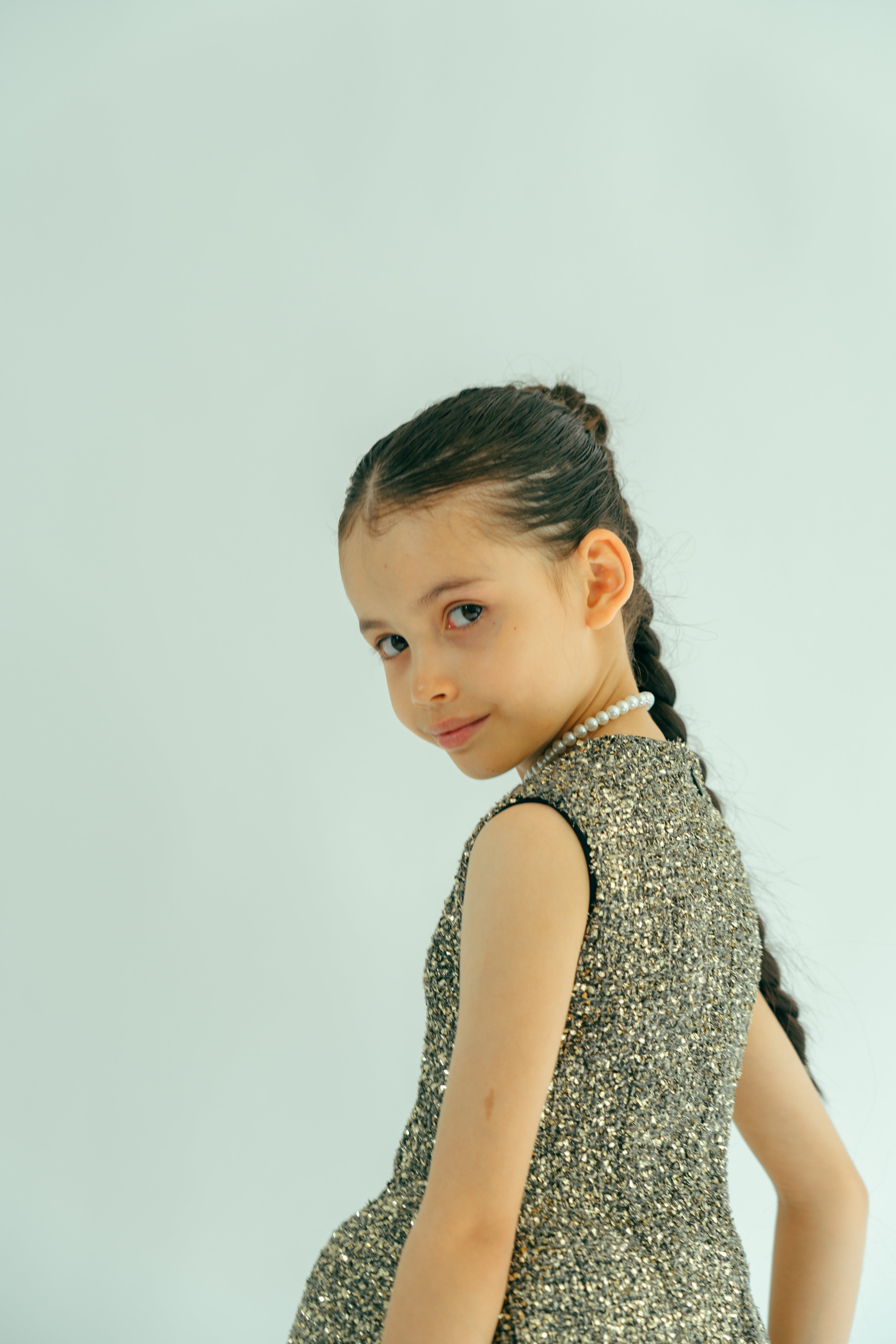 Girl wearing a gold shiny straight dress
