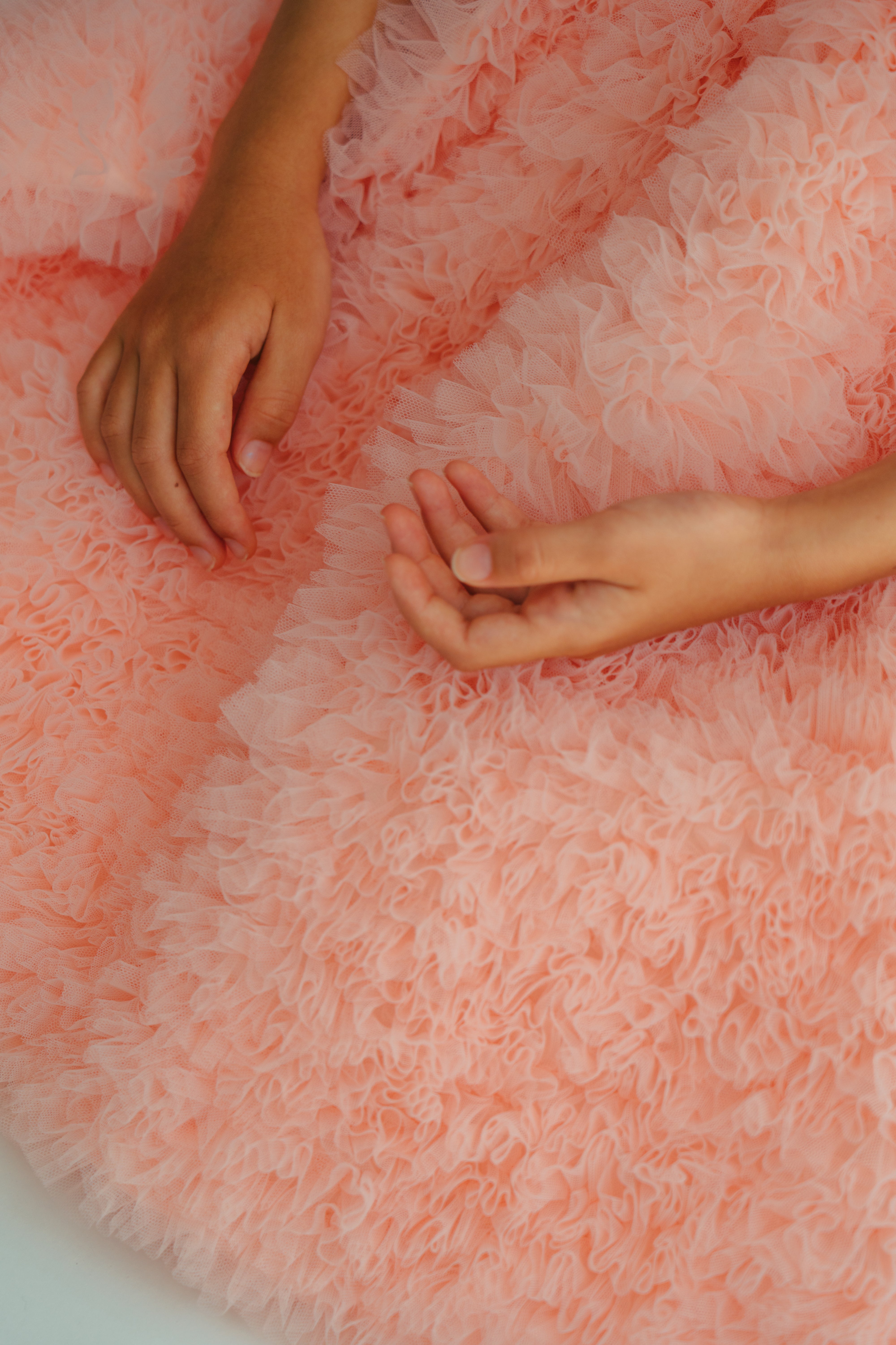 Close up on the frill details of the Sophia Dress in pastel pink