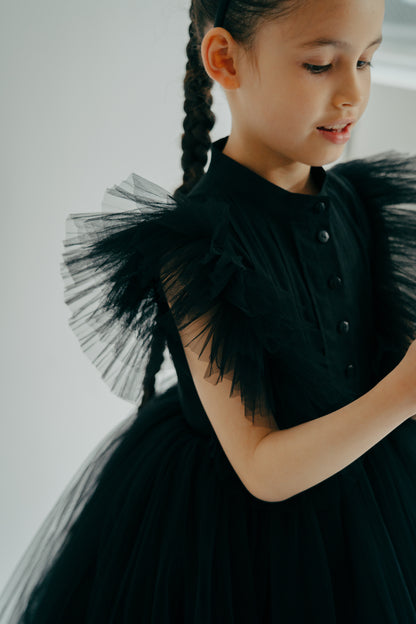 Girl in the Francine Black dress showing the sleeves' tulle details