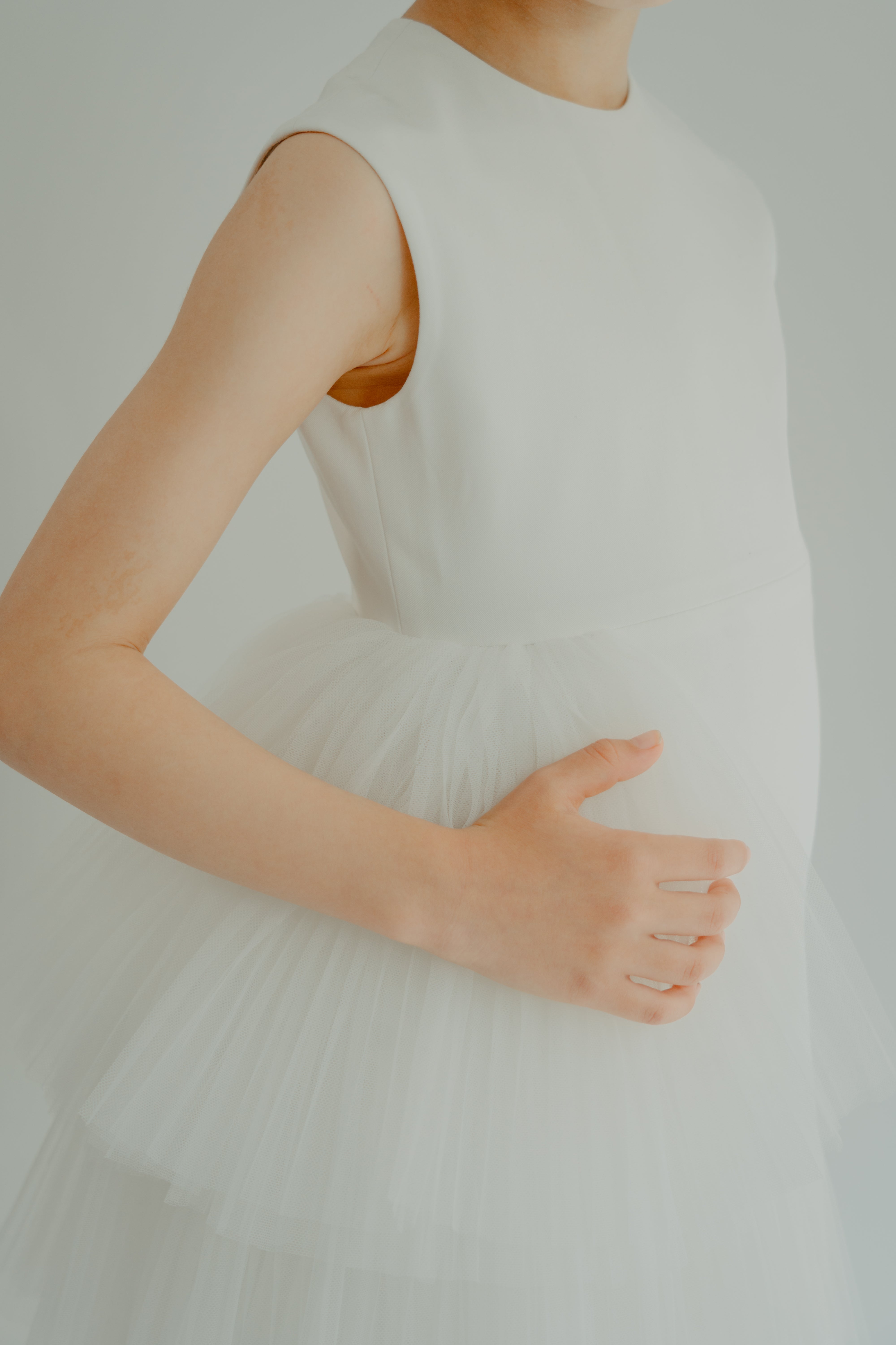 Close up on the asymmetrical tulle detail on kiki dress white