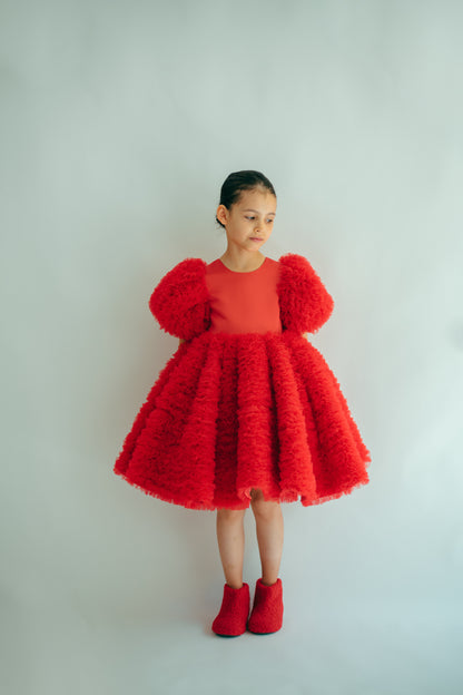 Young girl wearing the Sophia Dress in red