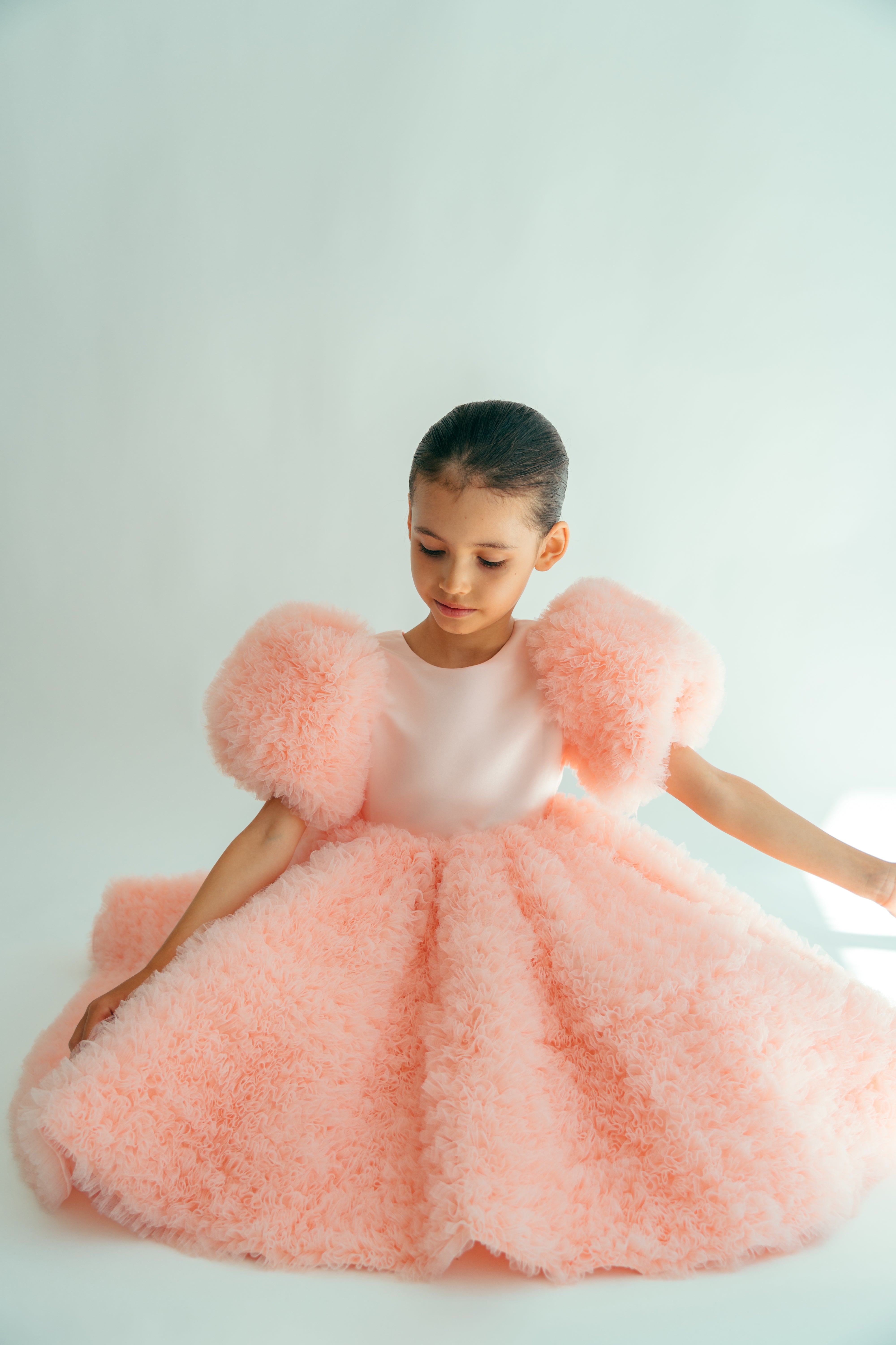 Girl wearing a puffy frilly pink dress